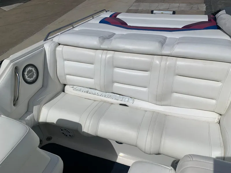 Slide: The Image of White leather seating on a 1996 Fountain 32 Fever boat, featuring sleek design and comfortable cushions. - 9