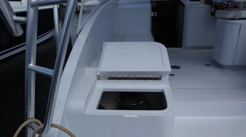 Slide: The Image of 2002 Miller Marine Express boat deck with storage compartment and seating area. - 10