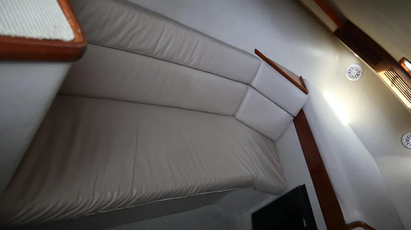 Slide: The Image of 2002 Miller Marine Express interior with beige seating and wooden accents. - 11