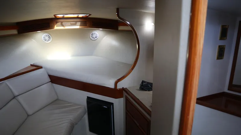 Slide: The Image of Interior of 2002 Miller Marine Express boat with cozy seating and bed area. - 14