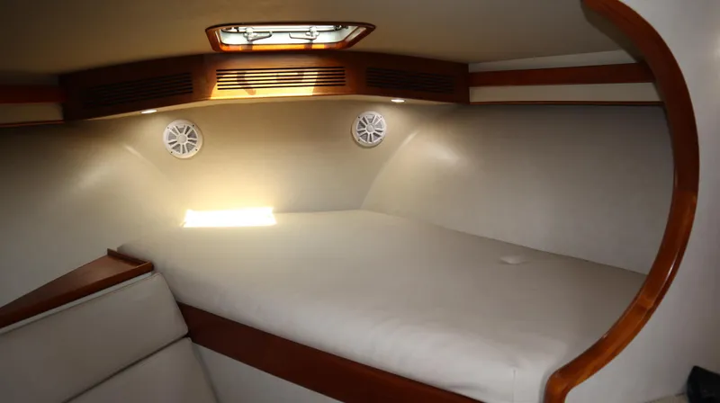 Slide: The Image of Interior cabin of 2002 Miller Marine Express boat with cozy bed and wooden accents. - 15
