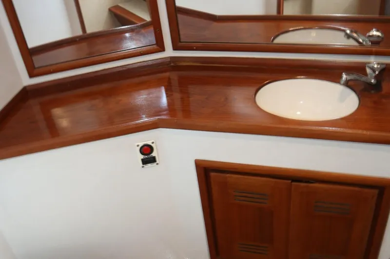 Slide: The Image of 2002 Miller Marine Express bathroom with wooden countertop and sink. - 17