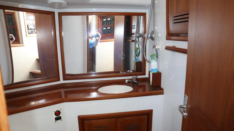 Slide: The Image of 2002 Miller Marine Express bathroom with wooden cabinetry and large mirror. - 18