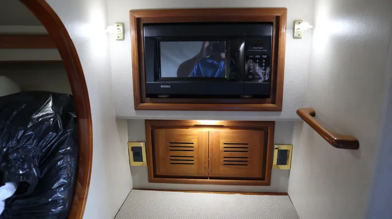 Slide: The Image of 2002 Miller Marine Express interior with microwave and wooden cabinetry. - 19
