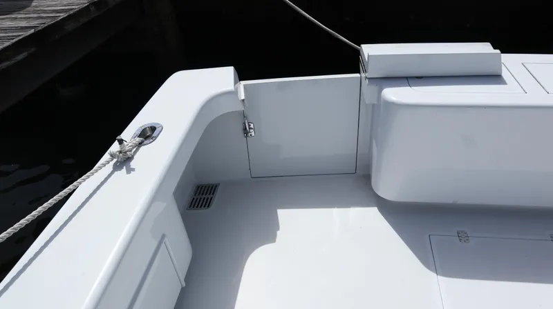 Slide: The Image of 2002 Miller Marine Express boat deck with clean white finish and rope detail. - 21
