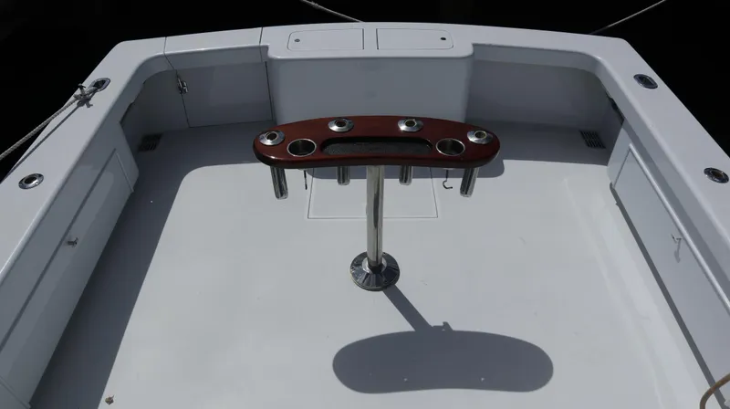 Slide: The Image of 2002 Miller Marine Express boat deck with rod holders and clean layout. - 22