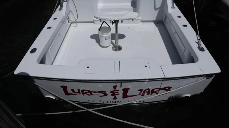 Slide: The Image of 2002 Miller Marine Express boat with "Lures & Liars" text, docked in St. Thomas. - 25
