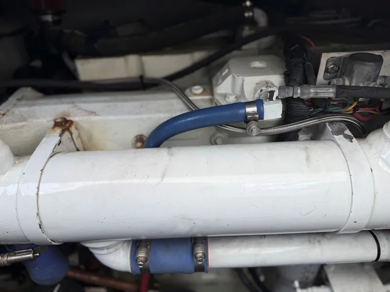 Slide: The Image of Engine room of 2002 Miller Marine Express with visible pipes and fittings. - 29