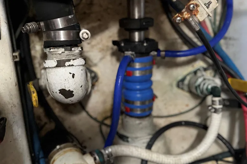 Slide: The Image of Engine compartment of a 2002 Miller Marine Express with visible hoses and fittings. - 30