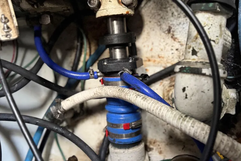 Slide: The Image of 2002 Miller Marine 36 Express boat on calm water with lush green background. - 31