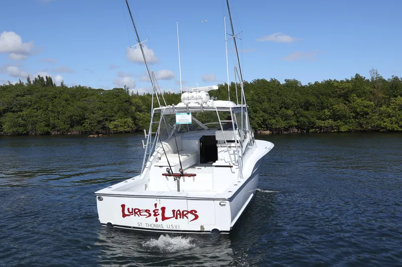 Slide: The Image of 2002 Miller Marine 36 Express boat on water, labeled "Lures & Liars," St. Thomas, USVI. - 35