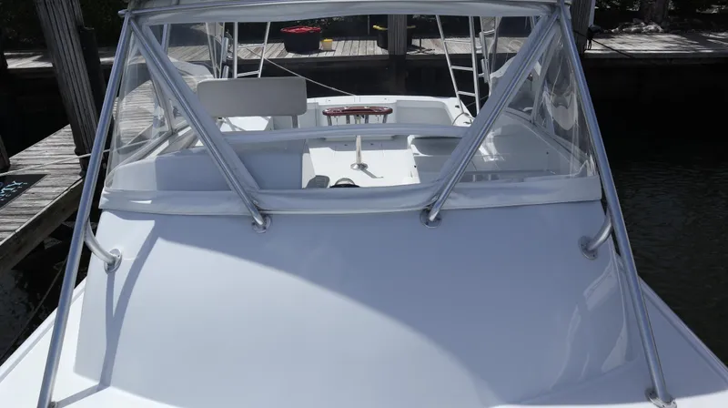 Slide: The Image of 2002 Miller Marine Express boat docked, showcasing sleek design and spacious deck. - 7