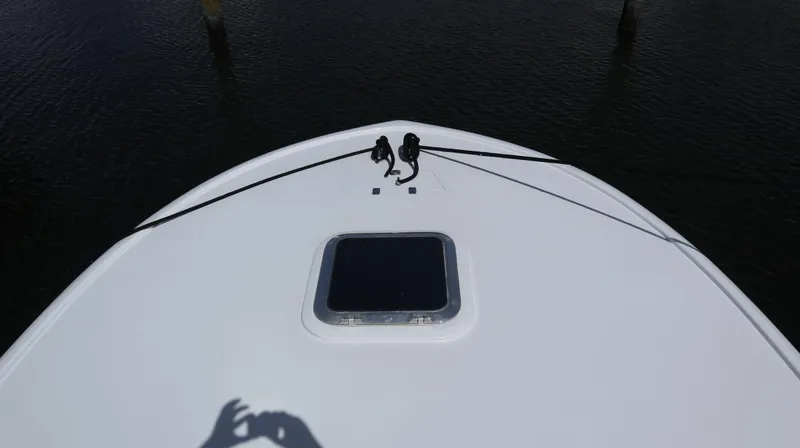 Slide: The Image of Bow of 2002 Miller Marine Express boat with hatch, docked on calm water. - 9
