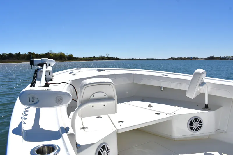 Slide: The Image of 2023 Pair Customs 24 Center Console MV boat on calm water, featuring modern seating and equipment. - 13