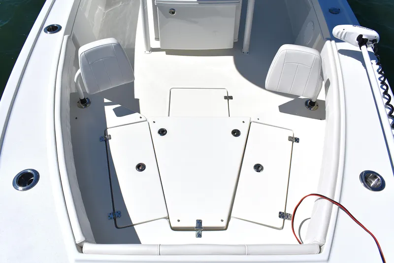 Slide: The Image of 2023 Pair Customs 24 Center Console MV boat interior with seating and storage compartments. - 14