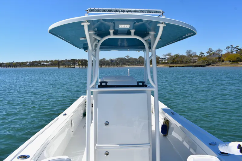 Slide: The Image of 2023 Pair Customs 24 Center Console MV boat on calm water, featuring sleek design and spacious deck. - 16