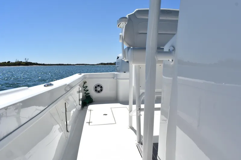 Slide: The Image of 2023 Pair Customs 24 Center Console MV boat on water, showcasing sleek deck design. - 17