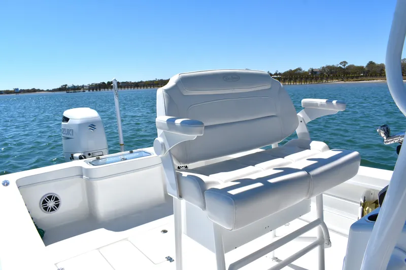 Slide: The Image of 2023 Pair Customs 24 Center Console MV boat with white seating on calm water. - 18