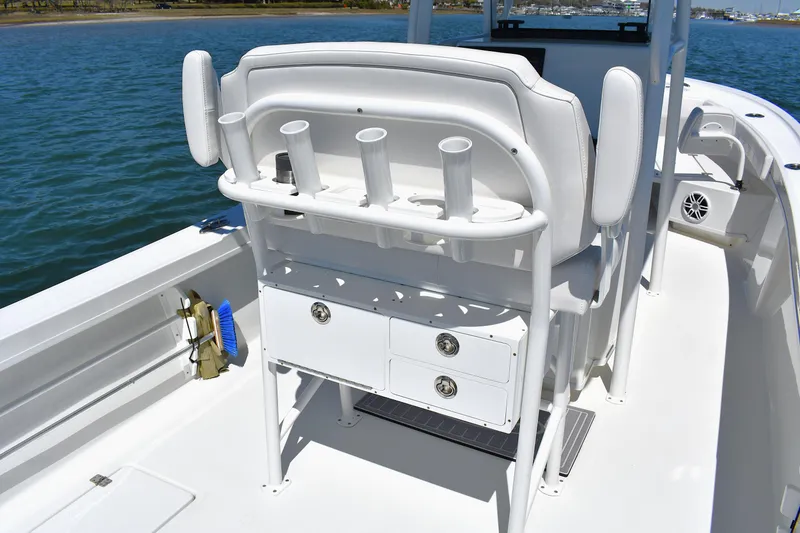 Slide: The Image of 2023 Pair Customs 24 Center Console MV boat interior with rod holders and storage drawers. - 24