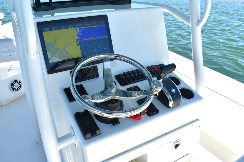 Slide: The Image of 2023 Pair Customs 24 Center Console MV dashboard with steering wheel and navigation display. - 26