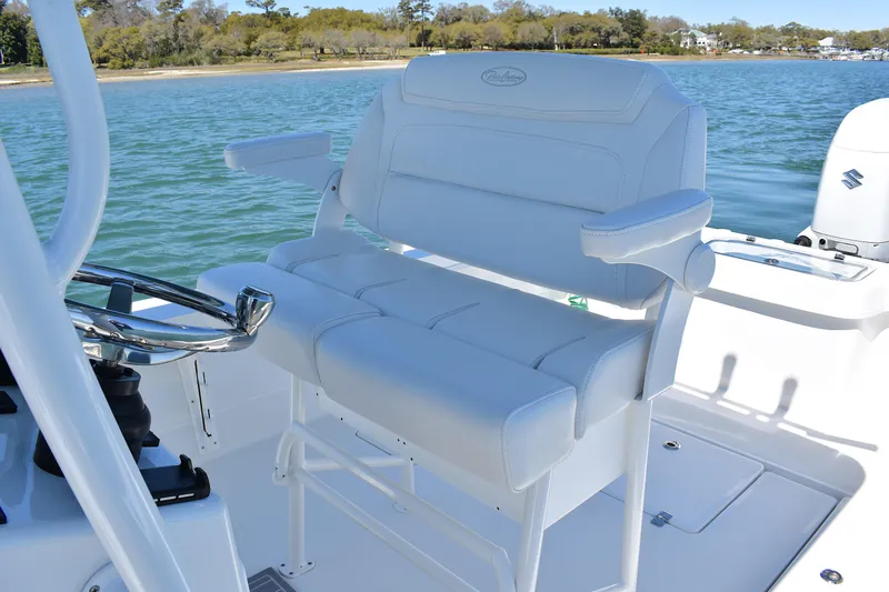 Slide: The Image of 2023 Pair Customs 24 Center Console MV boat with white seating on a sunny day. - 27