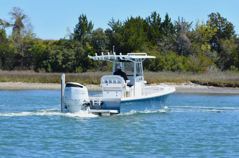 Slide: The Image of 2023 Pair Customs 24 Center Console MV boat cruising on a calm waterway. - 3