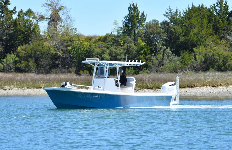 Slide: The Image of 2023 Pair Customs 24 Center Console MV boat cruising on a serene waterway. - 7