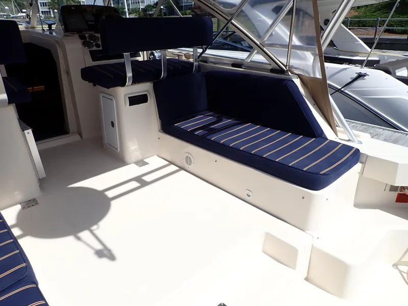 Slide: The Image of 2004 Mainship 34 Rum Runner II boat interior with blue cushioned seating. - 10