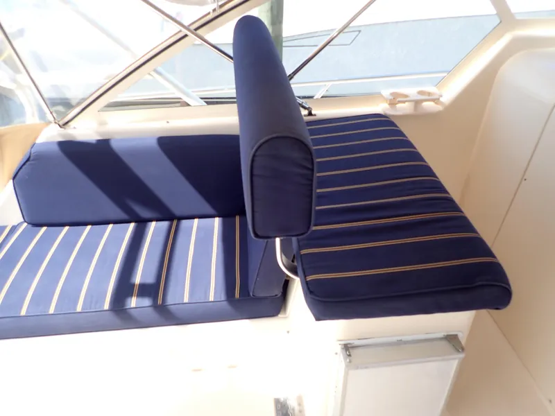 Slide: The Image of 2004 Mainship 34 Rum Runner II boat interior with blue striped seating. - 11