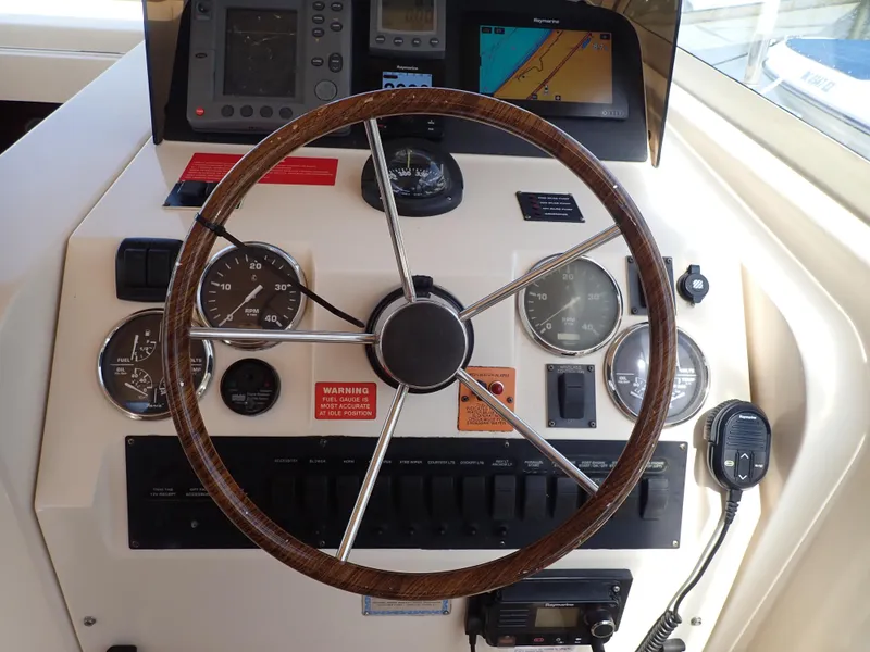 Slide: The Image of Helm of 2004 Mainship 34 Rum Runner II with gauges and navigation equipment. - 14
