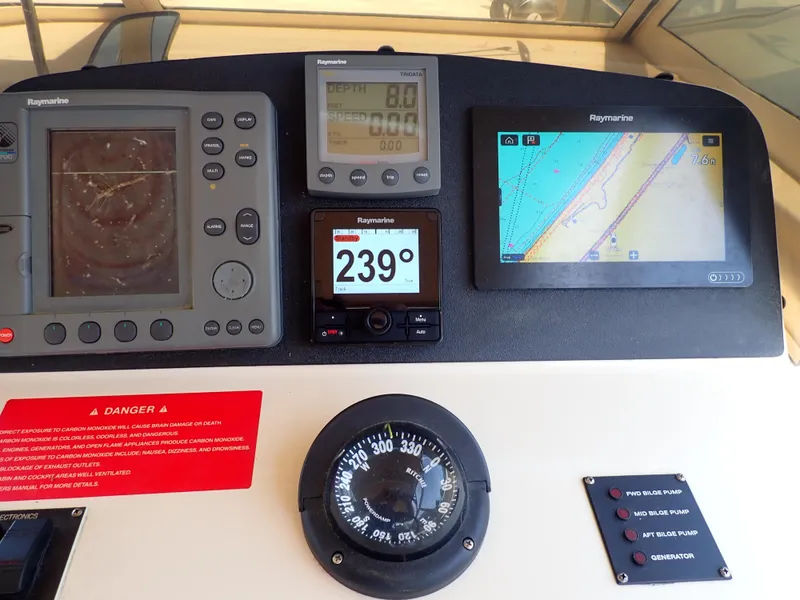 Slide: The Image of Dashboard of 2004 Mainship 34 Rum Runner II with navigation instruments and compass. - 15