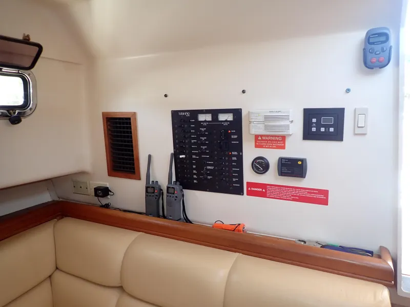 Slide: The Image of Control panel area inside a 2004 Mainship 34 Rum Runner II boat cabin. - 32