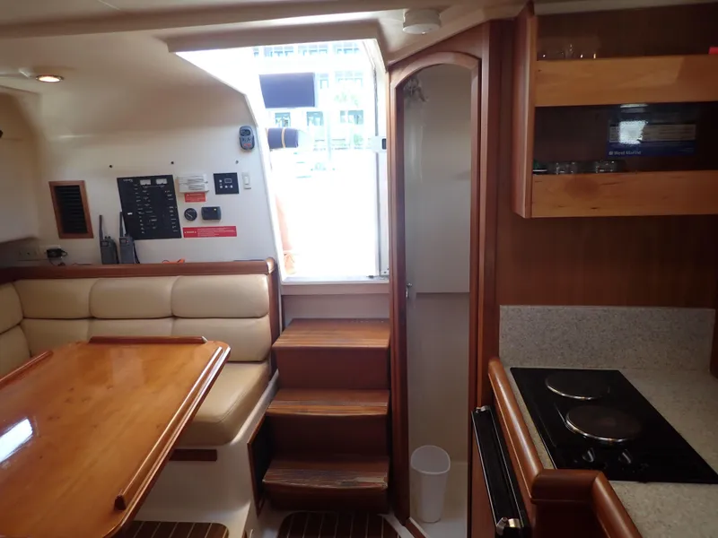 Slide: The Image of Interior of 2004 Mainship 34 Rum Runner II with dining area and kitchenette. - 33