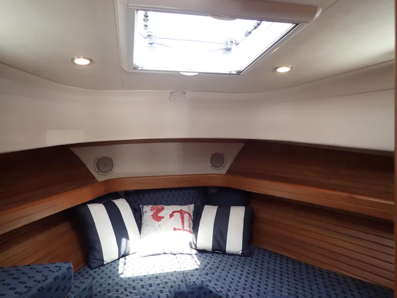 Slide: The Image of Cozy cabin interior of 2004 Mainship 34 Rum Runner II with nautical-themed cushions. - 36