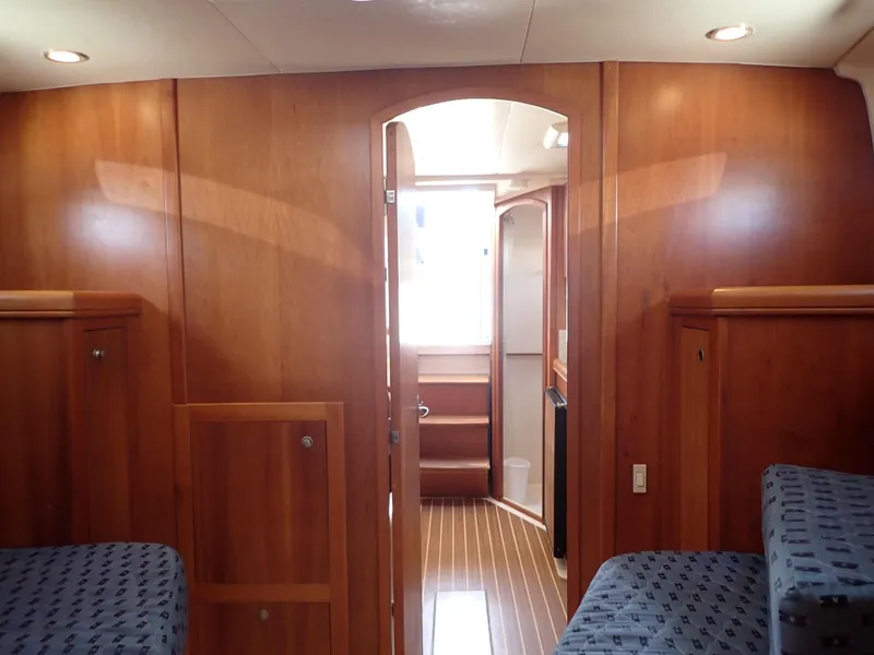 Slide: The Image of Interior of 2004 Mainship 34 Rum Runner II with wood paneling and cozy seating. - 37
