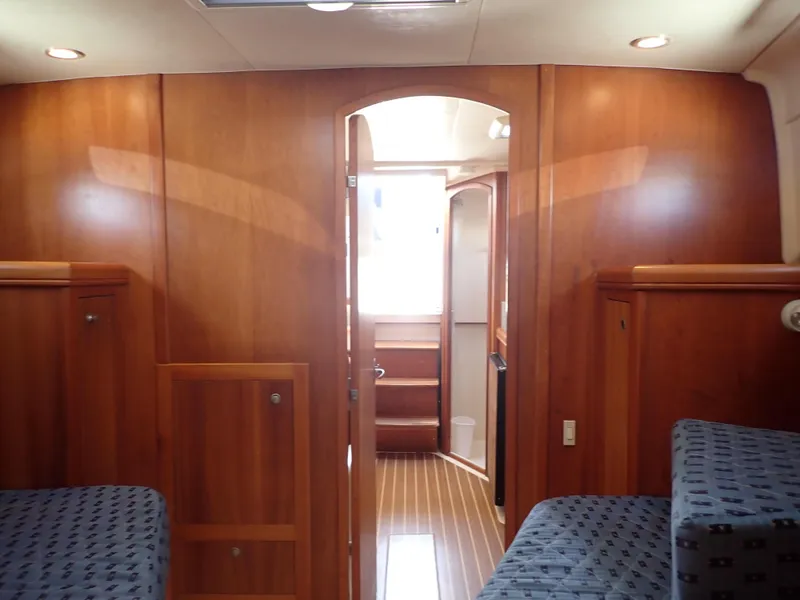 Slide: The Image of 2004 Mainship 34 Rum Runner II cabin interior with wood paneling and seating. - 38