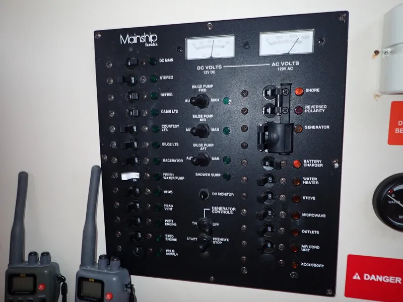Slide: The Image of Control panel of a 2004 Mainship 34 Rum Runner II boat with various switches and gauges. - 39