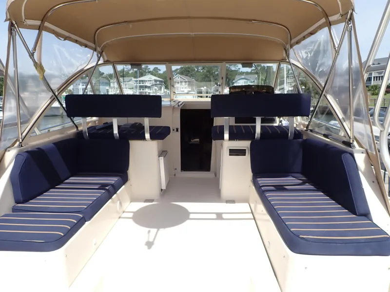 Slide: The Image of 2004 Mainship 34 Rum Runner II boat interior with blue seating and canopy. - 7