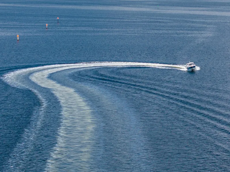 Slide: The Image of 2019 Boston Whaler 420 Outrage interior with sleek wood paneling and stainless steel appliance. - 14