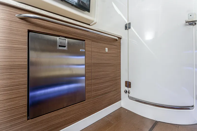 Slide: The Image of 2019 Boston Whaler 420 Outrage docked in a sunny marina with palm trees. - 15