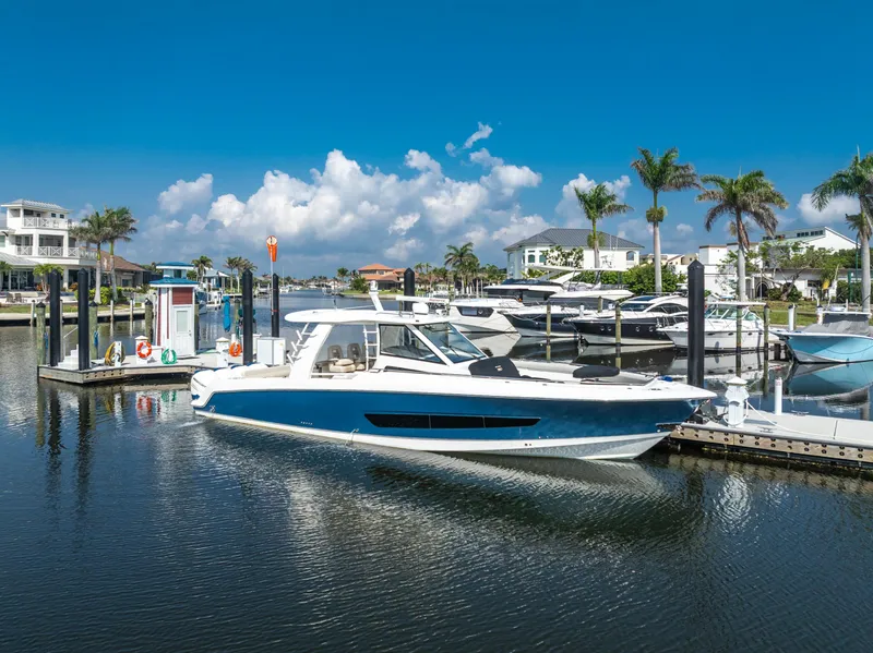 Slide: The Image of 2019 Boston Whaler 420 Outrage interior with modern seating, kitchenette, and ambient lighting. - 43
