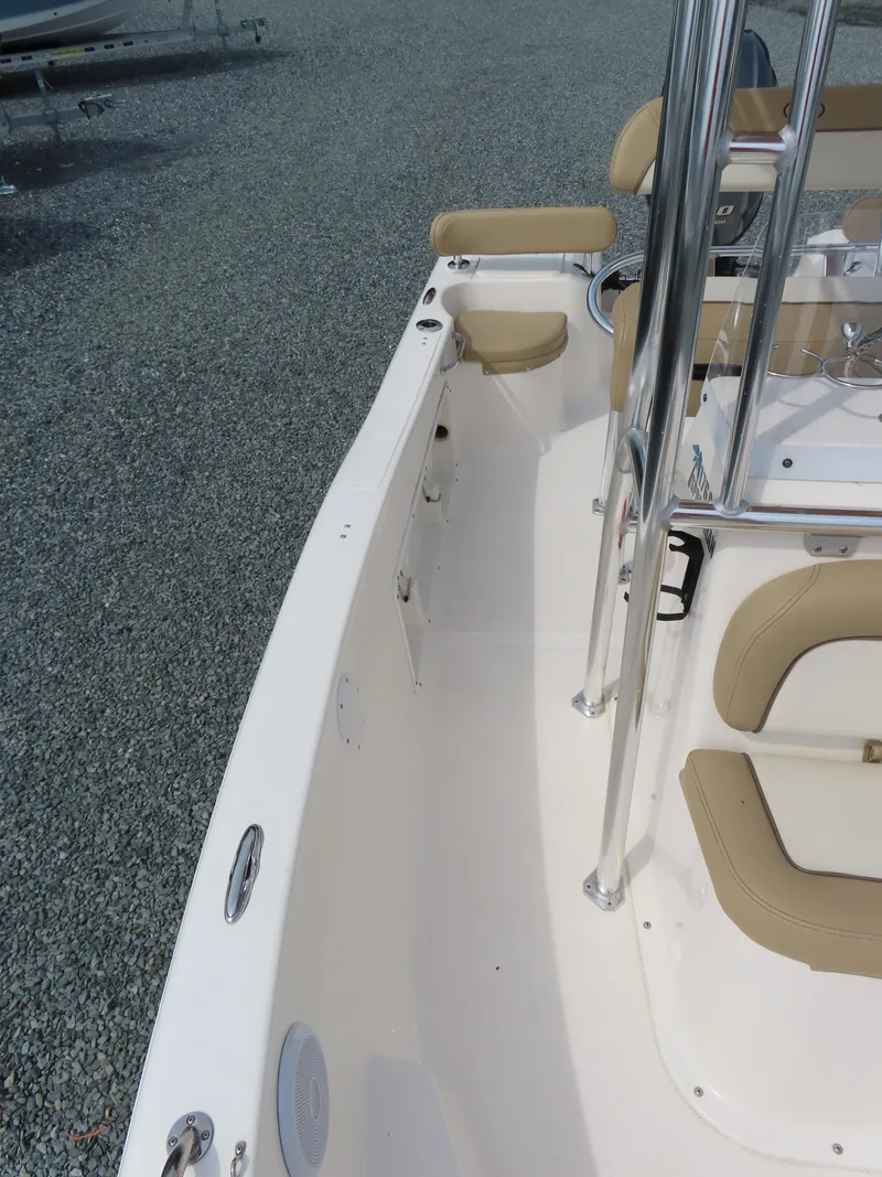 Slide: The Image of 2019 Key West 176 Center Console boat interior with beige seating and stainless steel railings. - 13