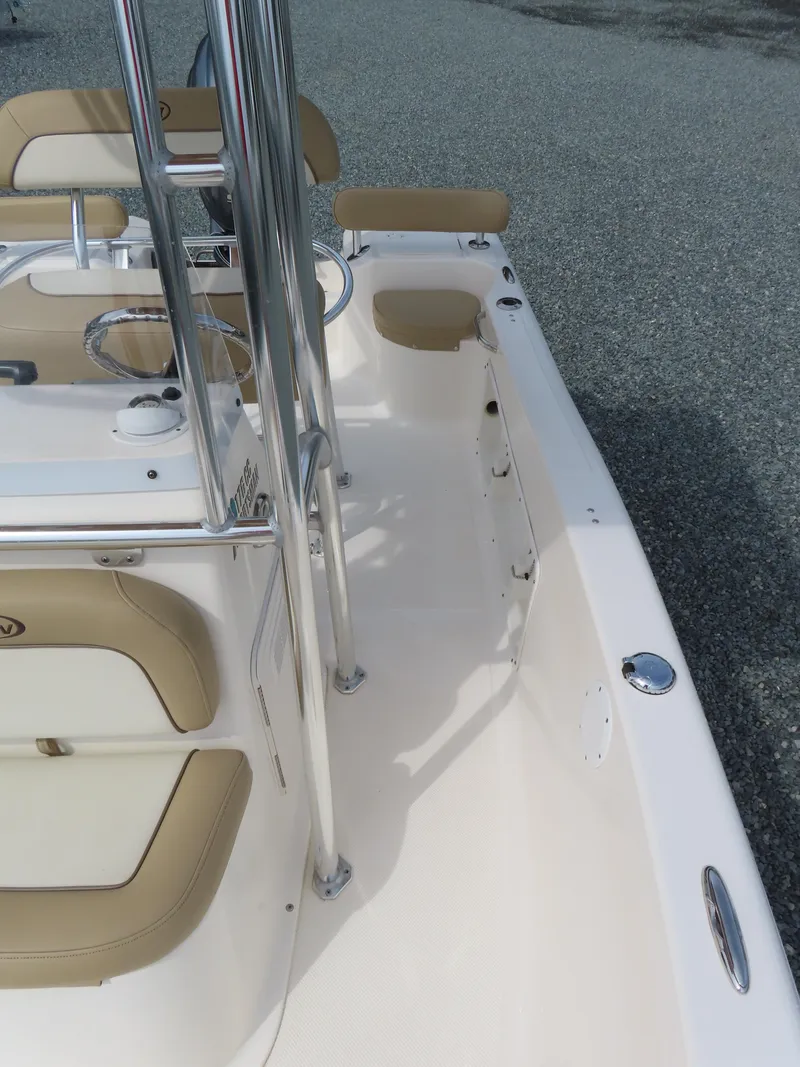 Slide: The Image of 2019 Key West 176 Center Console boat interior with beige seating and stainless steel fixtures. - 14