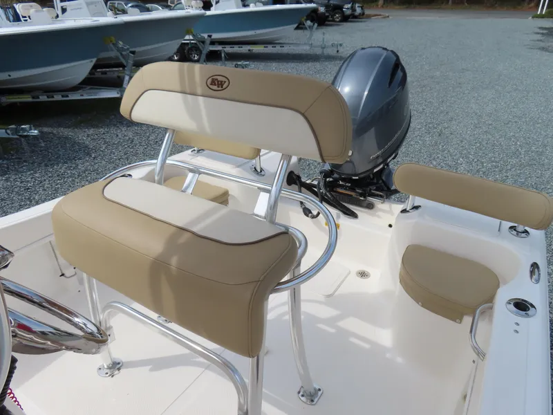 Slide: The Image of 2019 Key West 176 Center Console boat with tan seating and outboard motor. - 17