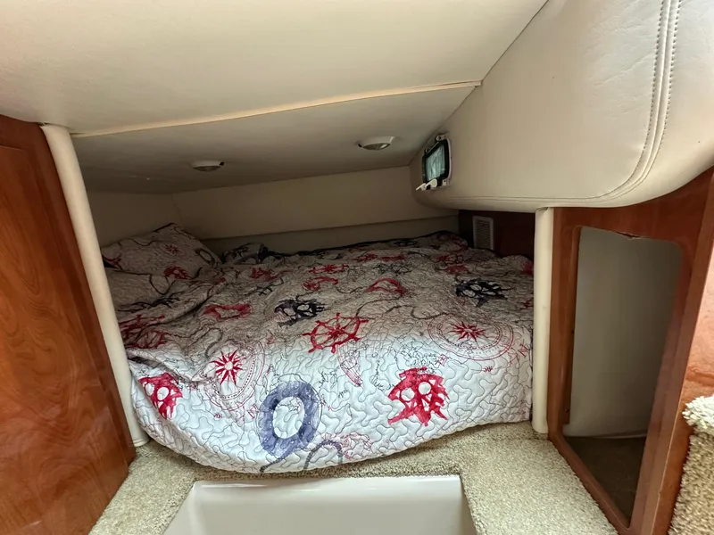 Slide: The Image of 2005 Four Winns 268 Vista cabin interior with nautical-themed bedding. - 10