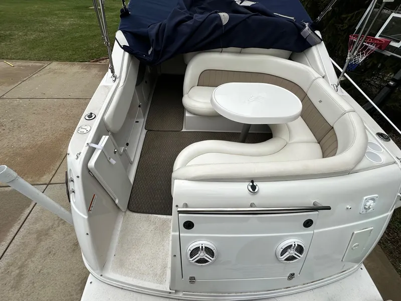 Slide: The Image of 2005 Four Winns 268 Vista boat with white seating and table in the cockpit area. - 5