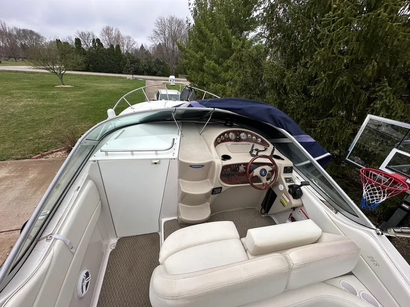 Slide: The Image of 2005 Four Winns 268 Vista boat interior with steering wheel and seating. - 6