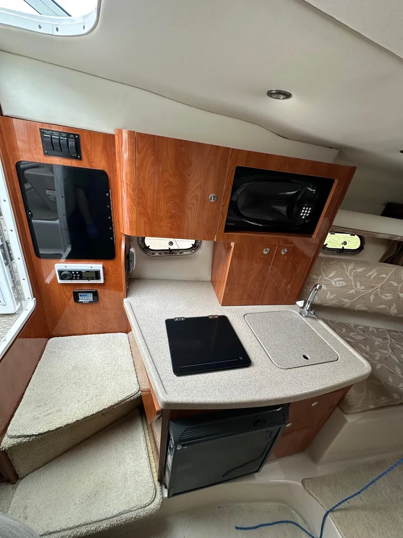Slide: The Image of 2005 Four Winns 268 Vista cabin interior with kitchenette and seating area. - 7