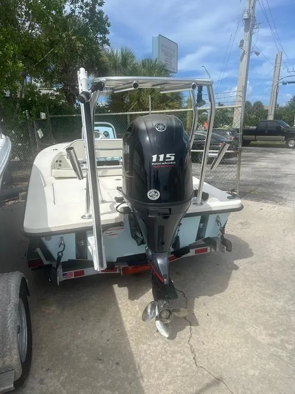 Slide: The Image of 2023 Maverick 18 HPX-V boat with Yamaha 115 outboard motor, parked outdoors. - 6