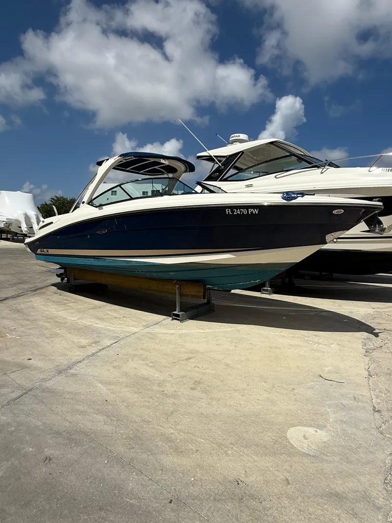 Slide: The Image of 2014 Sea Ray 270 SLX boat on a sunny day at a marina. - 7